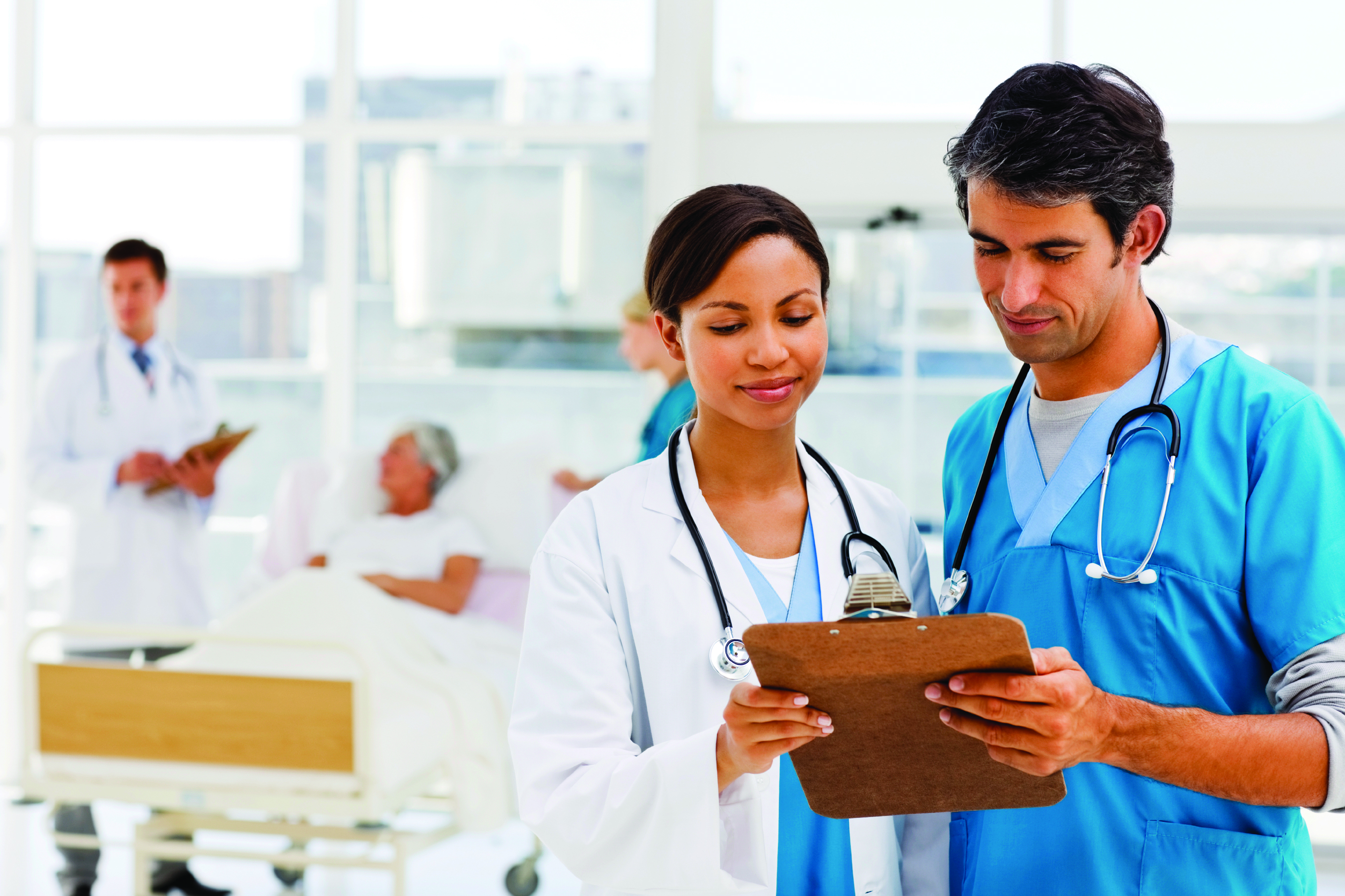 Two hospitalists look over a clipboard